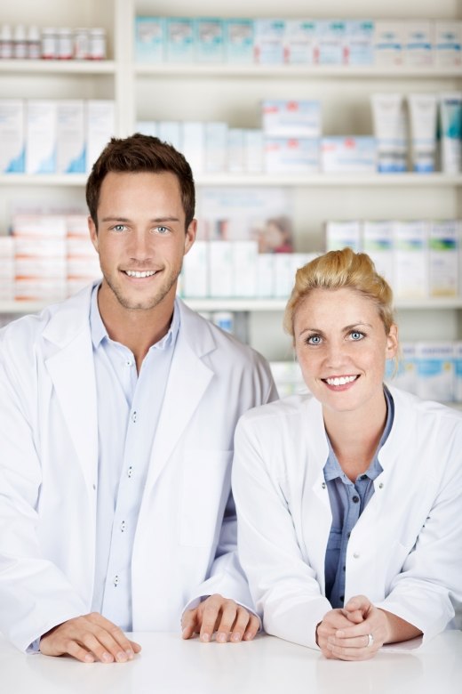 male and female pharmacist behind the counter